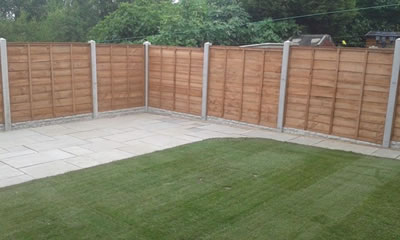 Patio, turf and fence panels in a garden in Castleford.